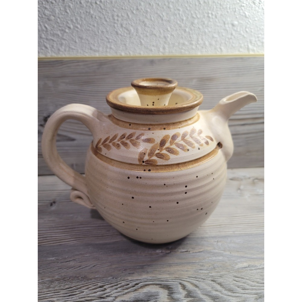 Stoneware Studio Pottery teapot with cream glaze and brown leaf motifs. signed